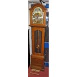 A contemporary oak long case clock, having a moon phase arched brass dial, three train movement,