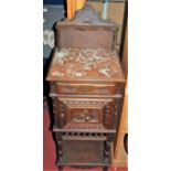 A late 19th century French carved oak ledgeback pot cupboard, having rouge marble inset top with