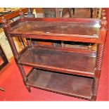 A late Victorian walnut three-tier buffet, having turned and reeded finials and on further spiral