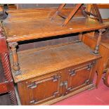 A late Victorian oak ledgeback two-tier buffet, having twin geometric moulded lower panelled