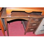 A 1930s oak single pedestal drop-flap writing desk, max width 123.5cm