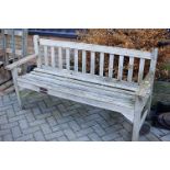 A modern slatted teak three-seater garden bench, width 159.5cm