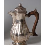 A 19th century continental (probably German) silver hot water jug, of fluted bell shape, having