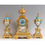 A 19th century gilt bronze and porcelain inset three-piece clock garniture, the clock surmounted