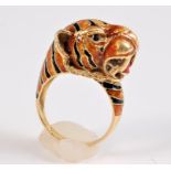 *An 18ct enamelled tiger ring, the naturalistically modelled tigers head enamelled in orange and