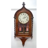 A Victorian figured walnut droptrunk wall clock, the Gothic influenced case enclosing circular white