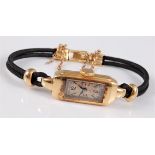 A lady's c.1930's 18ct Patek Philippe wristwatch, the tank style watch with cream dial, black Arabic