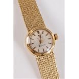A lady's 18ct Omega Ladymatic wristwatch, the signed round satin finish dial with gilt baton