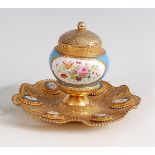 A circa 1900 French gilt metal and porcelain inkstand, having hinged cover, decorated in bright