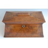 *A circa 1830 walnut tea caddy, of sarcophagus form, the hinged lid opening to reveal fitted