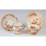 *A Royal Worcester reticulated cabinet cup and saucer, on a white ground with painted floral