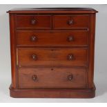 A Victorian mahogany round corner chest, of two short and three long graduated drawers, each