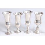 *A set of three Edwardian silver kiddush cups, each of typical tulip form, with stipple engraved