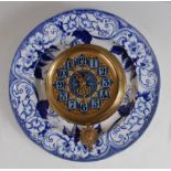 A late 19th century French brass wall clock, centred on a blue and white printed plate, the clock