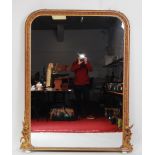 *A large mid-Victorian giltwood and gesso overmantel mirror, of arched form, having a fishscale