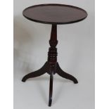 *A Regency mahogany occasional table, the circular dished top on a turned urn column to tripod base,
