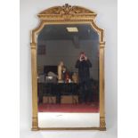 A mid-19th century giltwood and gesso overmantel mirror, the bevelled plate within a moulded