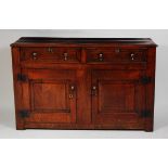 An early 18th century joined oak dresser base, the top having a moulded edge over twin frieze