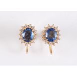 A pair of 18ct sapphire and white hardstone earrings, the oval pale blue sapphires, approx. 6.6mm