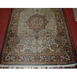 A Kashmiri hand-knotted silk rug, the cream ground decorated with a Star of Kashmir within a
