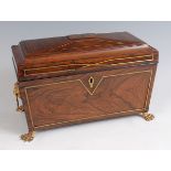 A Regency rosewood and brass inlaid tea caddy, of sarcophagus form, having fitted interior with