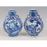 A pair of Chinese export moonflasks, each underglaze blue decorated, one with opposing reserves of