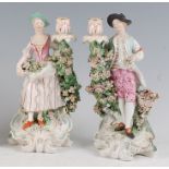 A pair of 18th century Derby porcelain figural candle-holders, modelled as a gallant and his