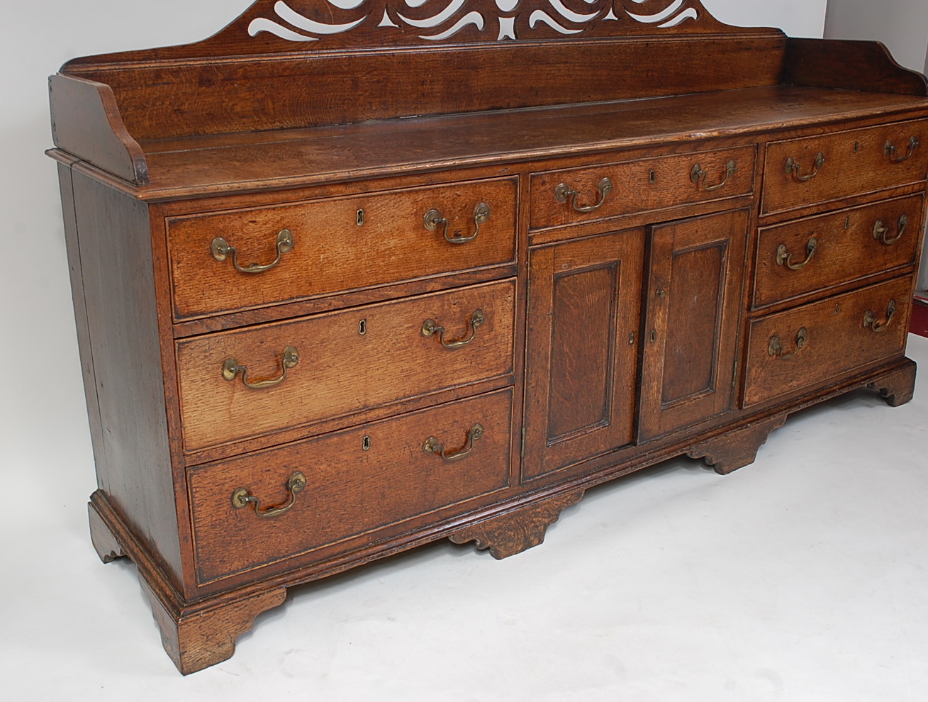 A George III oak Lancashire dresser, having a three-quarter gallery with pierced frieze, over an - Image 3 of 4