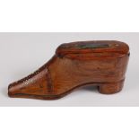 A 19th century treen shoe snuff, having brass pique decoration and sliding cover, 10cm