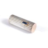 A French silver, gold and sapphire lipstick case by Mellerio dits Meller, the round reeded