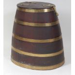 A 19th century coopered oak and brass bound barrel, having later adapted hinged cover, with