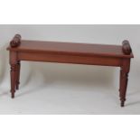 A Victorian style mahogany window seat, having applied scroll ends and on ring turned tapering