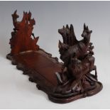 A circa 1900 Black Forest bookslide, the folding ends each carved as a pair of fauns in a