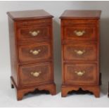 A pair of figured walnut bowfront bedside chests, each having a brushing slide over cross and