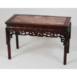 A 19th century Chinese rosewood occasional table, having marble inset top and blind carved frieze on