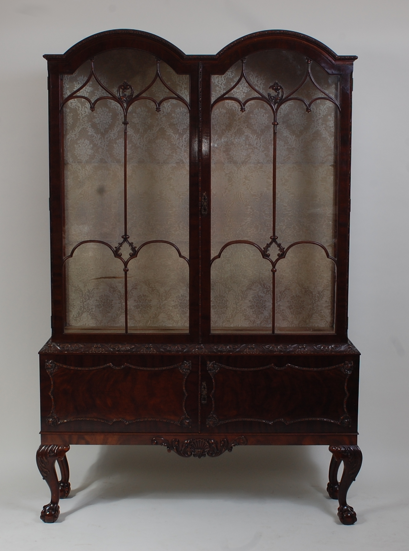 *An Edwardian mahogany double dome topped china display cabinet, having twin astragal glazed doors