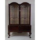*An Edwardian mahogany double dome topped china display cabinet, having twin astragal glazed doors