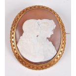 *A late 19th century cameo brooch, the oval shell cameo of an artist and palette with his muse, in