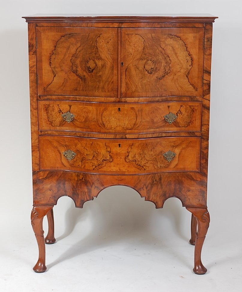 A figured walnut and crossbanded serpentine front side cabinet, in the 18th century style, the whole