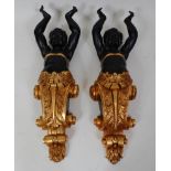 A pair of contemporary Blackamore carved wooden corbels, each in the form of a boy with arms
