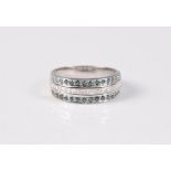 A blue and white diamond half hoop ring, the central channel set row of small princess cut diamonds,