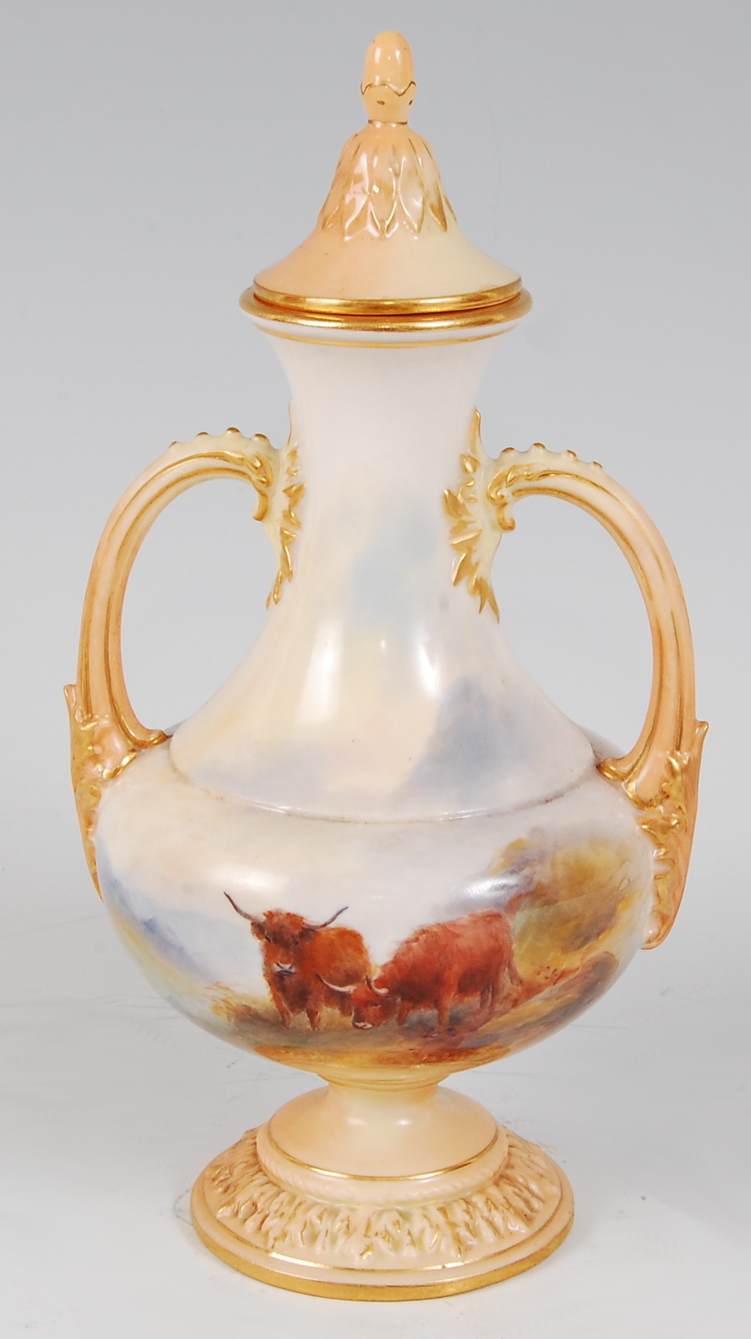 *A Royal Worcester porcelain twin handled vase and cover, hand-painted with Highland cattle amidst