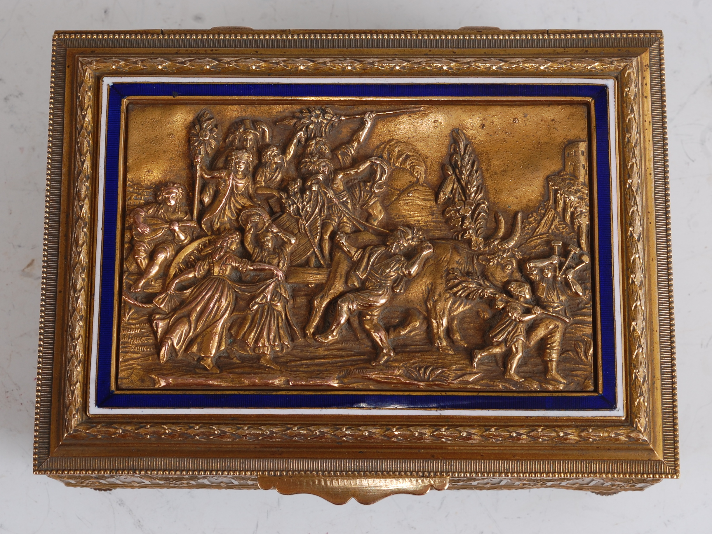 A late 19th century brass music box, the hinged cover cast with a scene of merry-making and - Image 2 of 3