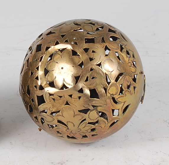 An early 19th century pierced and engraved brass incense ball, decorated as flowers and foliage, - Image 2 of 3