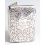 *An Edwardian silver pocket notebook case, of hinged rectangular form, having all-over foliate