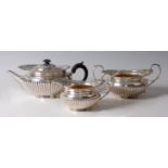 A well-matched Victorian silver three-piece tea set, comprising teapot, twin handled sugar and