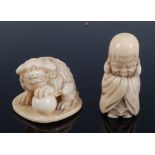 A Japanese Meiji period carved ivory netsuke of a shi-shi dog, its left foot upon a ball, signed