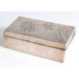 A Japanese Meiji period white metal clad table cigarette box, of rectangular form, the hinged lid