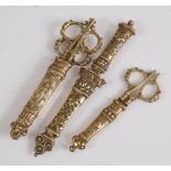 Two pairs of Victorian brass desk scissors, with single sheaf scabbard, 17.5cm; a single smaller