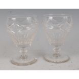 A pair of Regency glass rummers, each having diamond cut panels and thumb cut tapering bodies, to